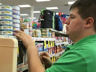 Student stocking shelves at store