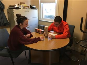 2 students sitting at a table